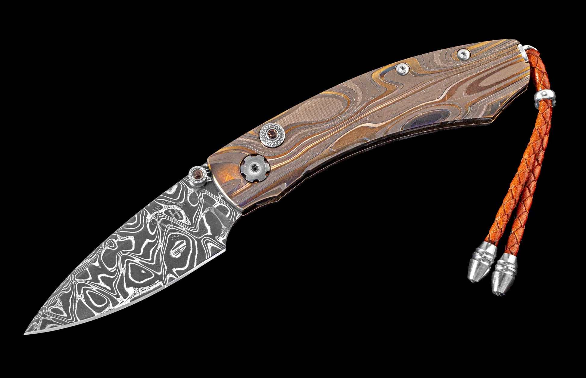One of a kind custom pocket knife from William Henry featuring a Laser color-engraved titanium frame and hand forged damascus steel blade