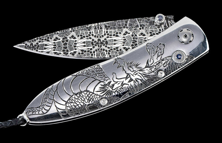 One of a kind custom William Henry Knife with hand-forged Damascus steel, hand-carved sterling silver, and sapphire. 