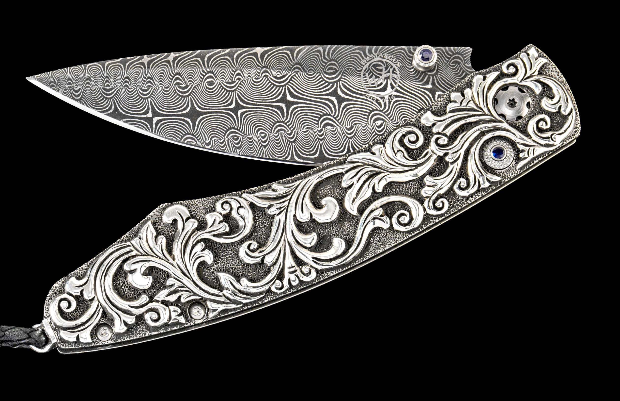 One of a kind William Henry custom knife with Damascus steel, Hand-carved sterling silver, and Sapphire