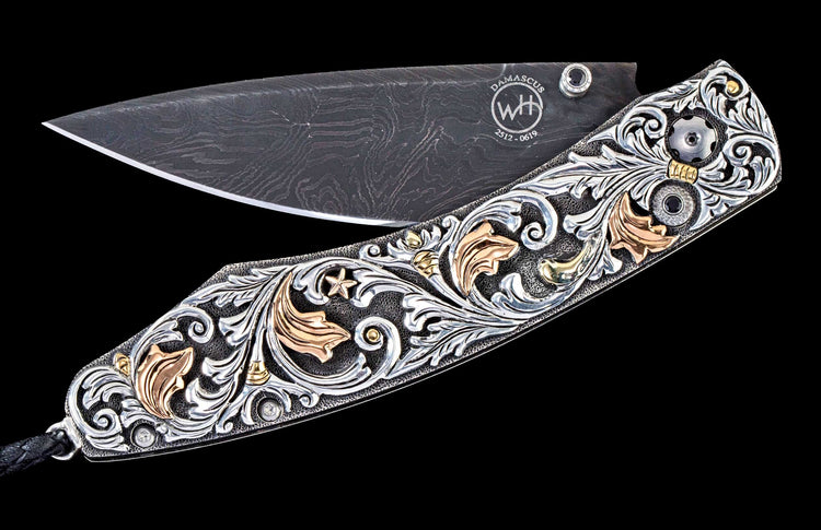One of a kind William Henry custom knife with Damascus steel, Hand-carved sterling silver w/gold, and Spinel gemstones.