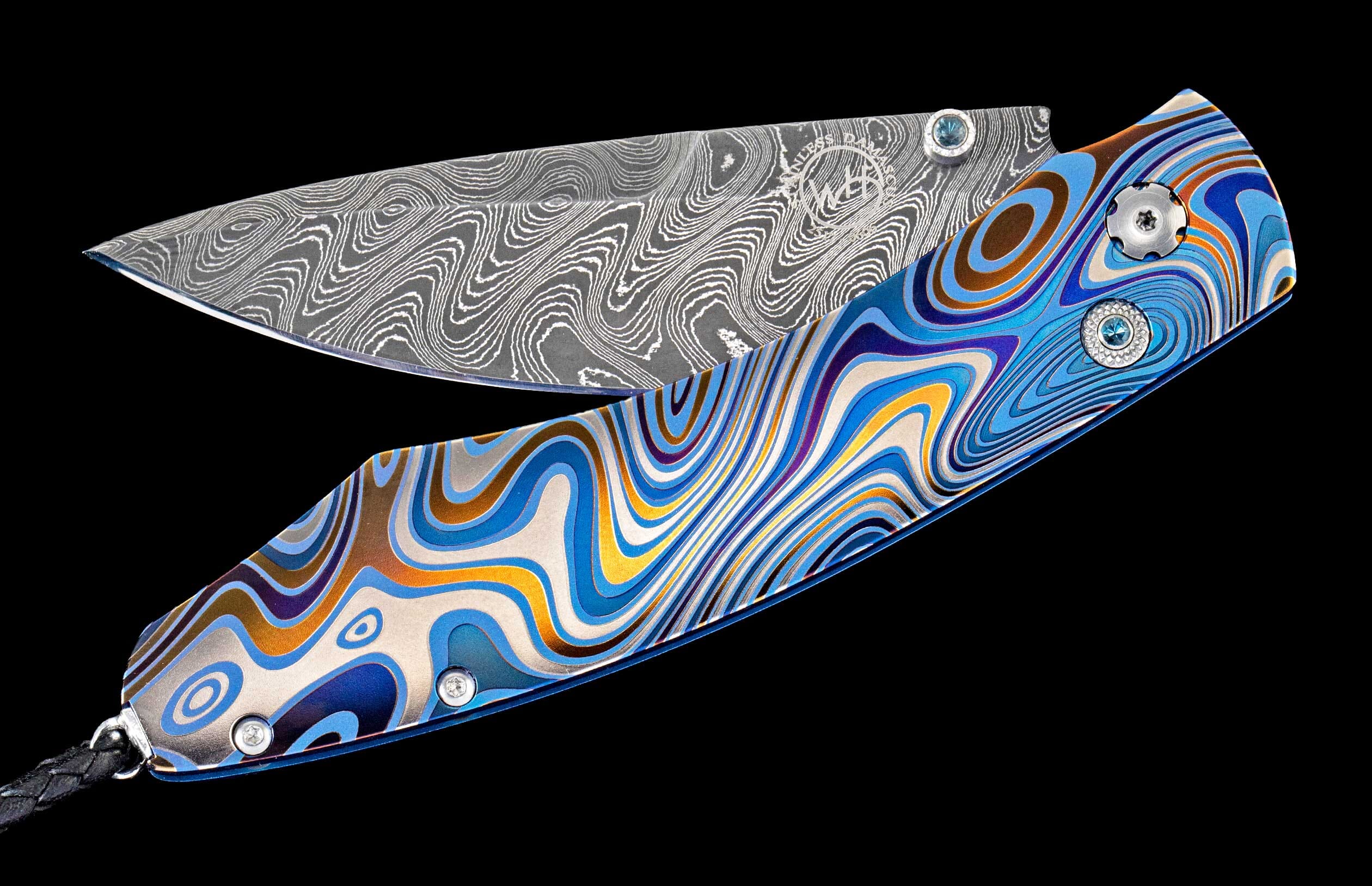 One of a kind William Henry custom knife with hand forged Damascus steel, Laser color-engraved titanium, and Kashmir Blue topaz gemstones.