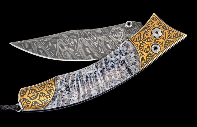 One of a kind William Henry custom knife with hand forged Damascus steel blade, Koftgari - inlaid 24K gold, Fossil coral, and Spinel gemstones.
