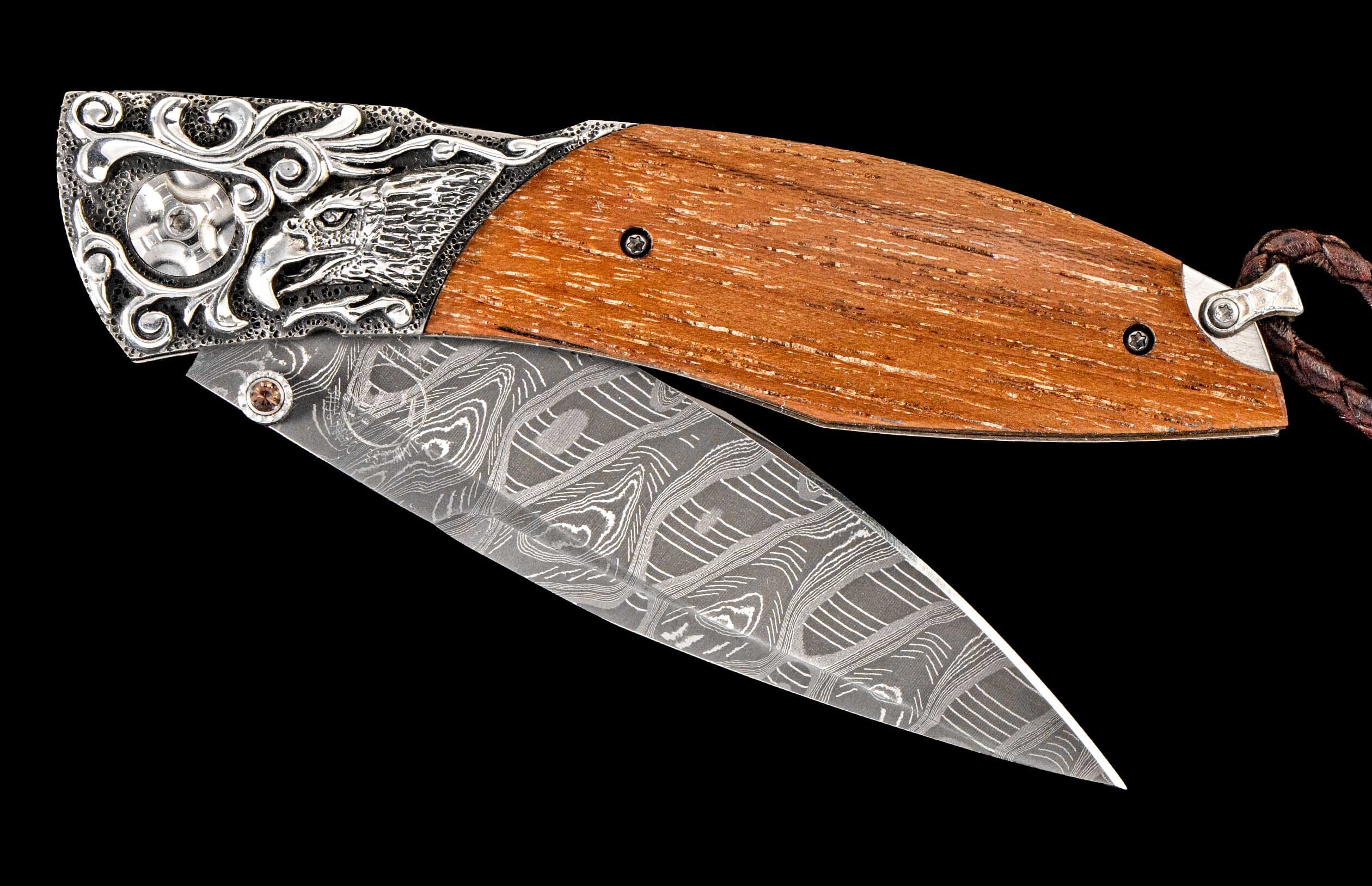 One of a kind William Henry custom knife with hand forged Damascus steel blade, Hand-carved sterling silver, 'USS California' wood, and Smoky Quartz gemstones.
