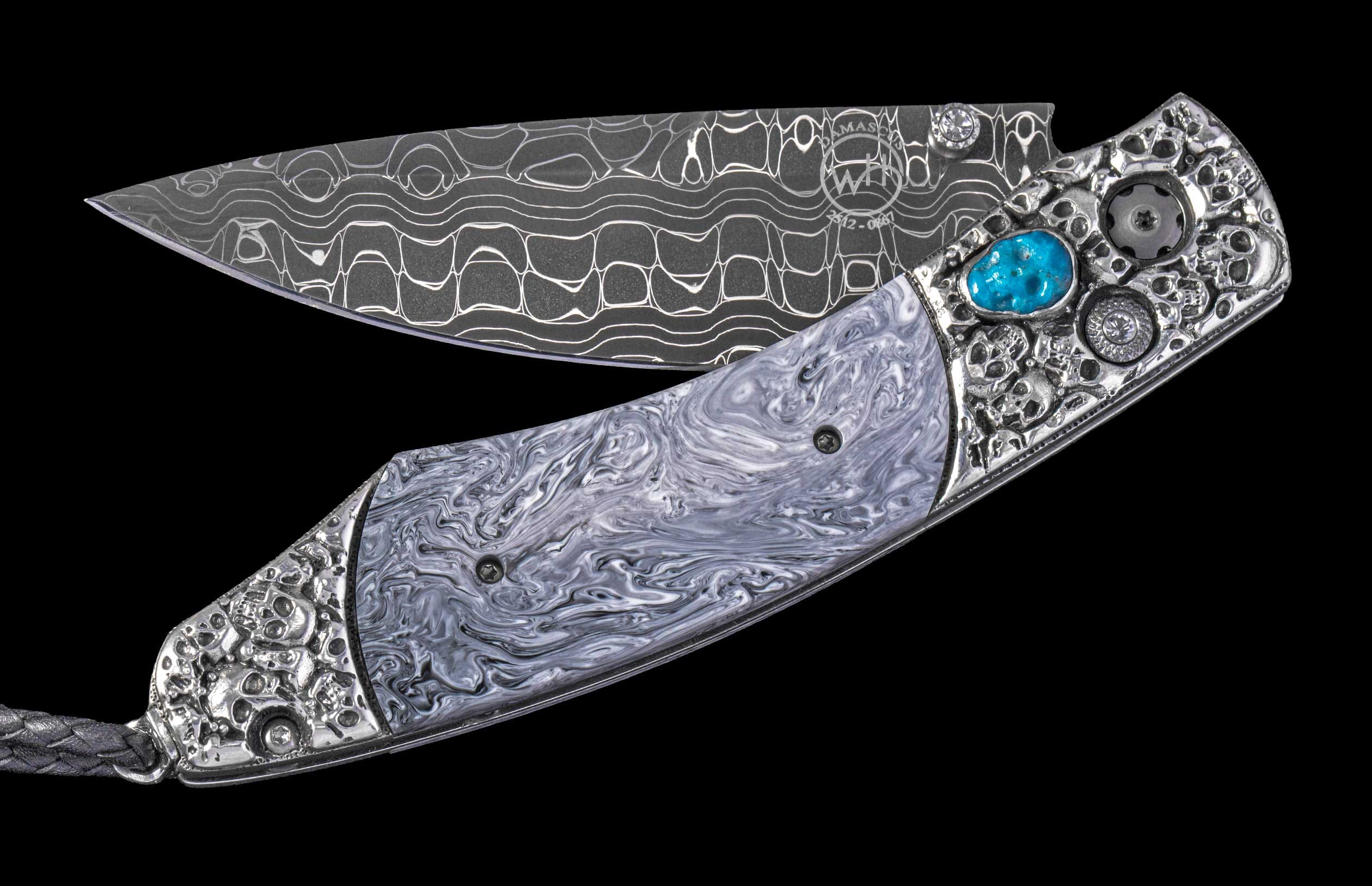 Open Damascus steel folding knife with swirling grey handle by WHB, featuring skull-patterned metal, a turquoise stone, and braided lanyard.