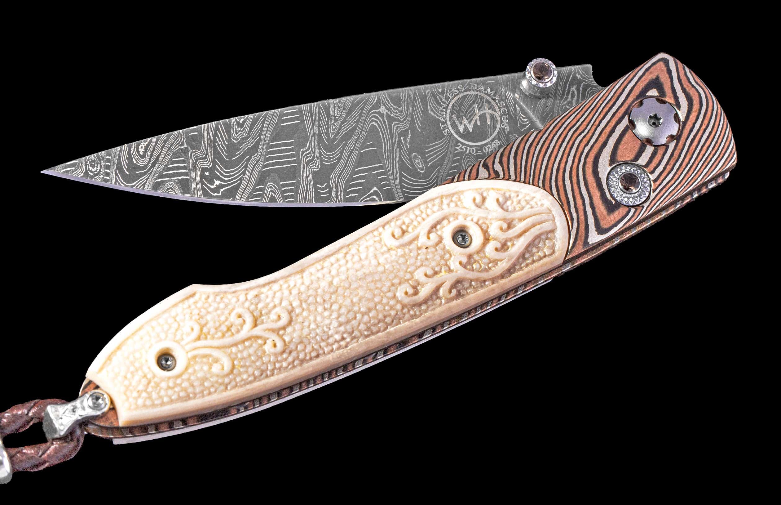 Folding knife with a wavy Damascus blade and 'WH' logo, featuring orange-brown striped and carved cream textured handle scales, plus a braided leather lanyard.