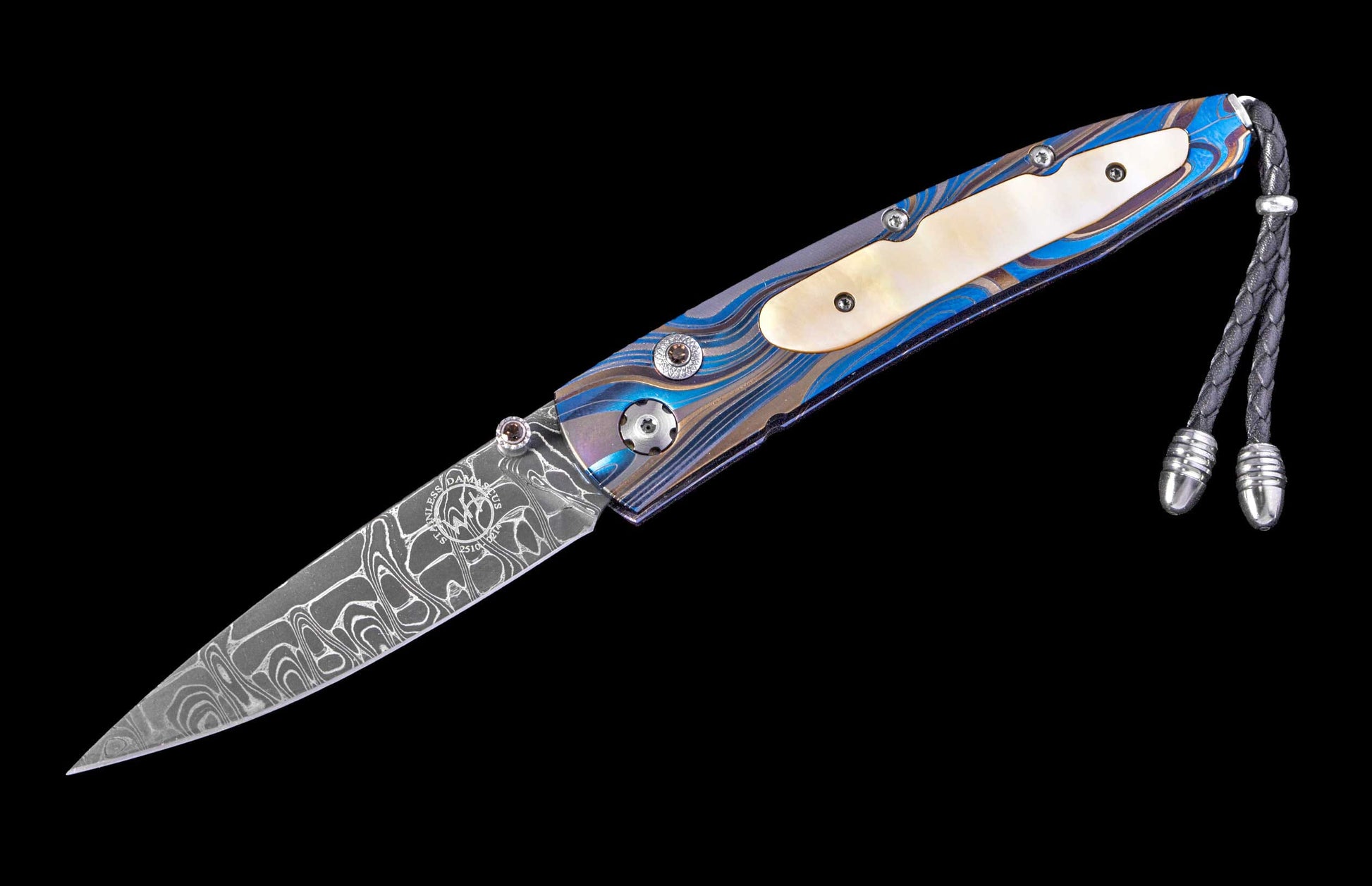 Diagonally angled folder knife with a stainless Damascus steel blade, a blue and gold patterned handle featuring a mother-of-pearl inlay, and a black braided leather lanyard.