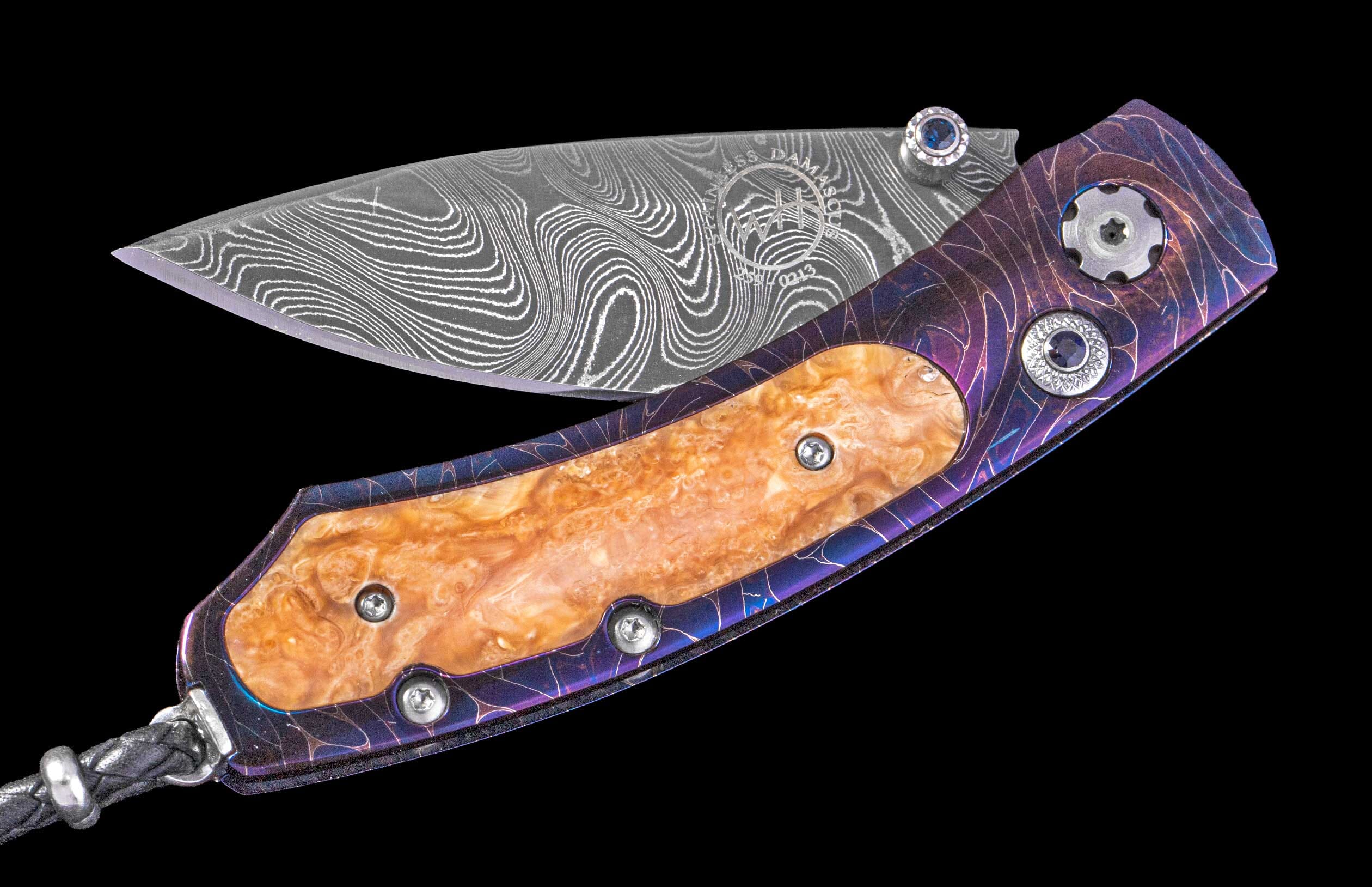 Folding knife with a patterned Damascus blade, iridescent purple and burl wood handle, and blue gem details, partially open.