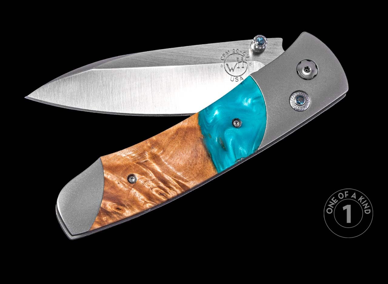 One of a Kind William Henry Custom Knife with titanium frame, Natural wood and resin scales, Blue topaz gems, and damascus steel blade.