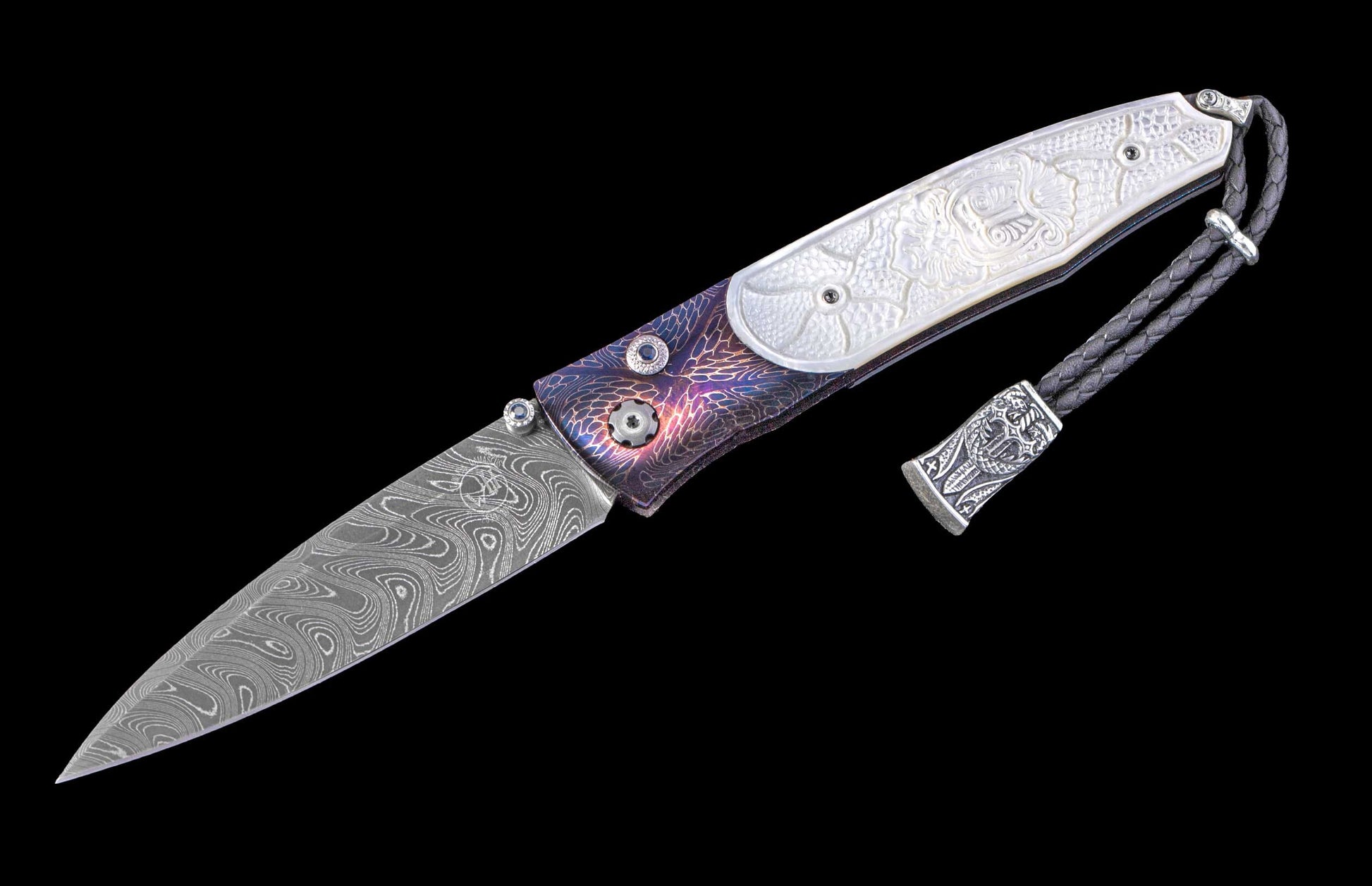 A folding knife with a swirling Damascus steel blade, iridescent purple and blue textured handle with white mother-of-pearl dragon inlay, and a black braided leather lanyard.