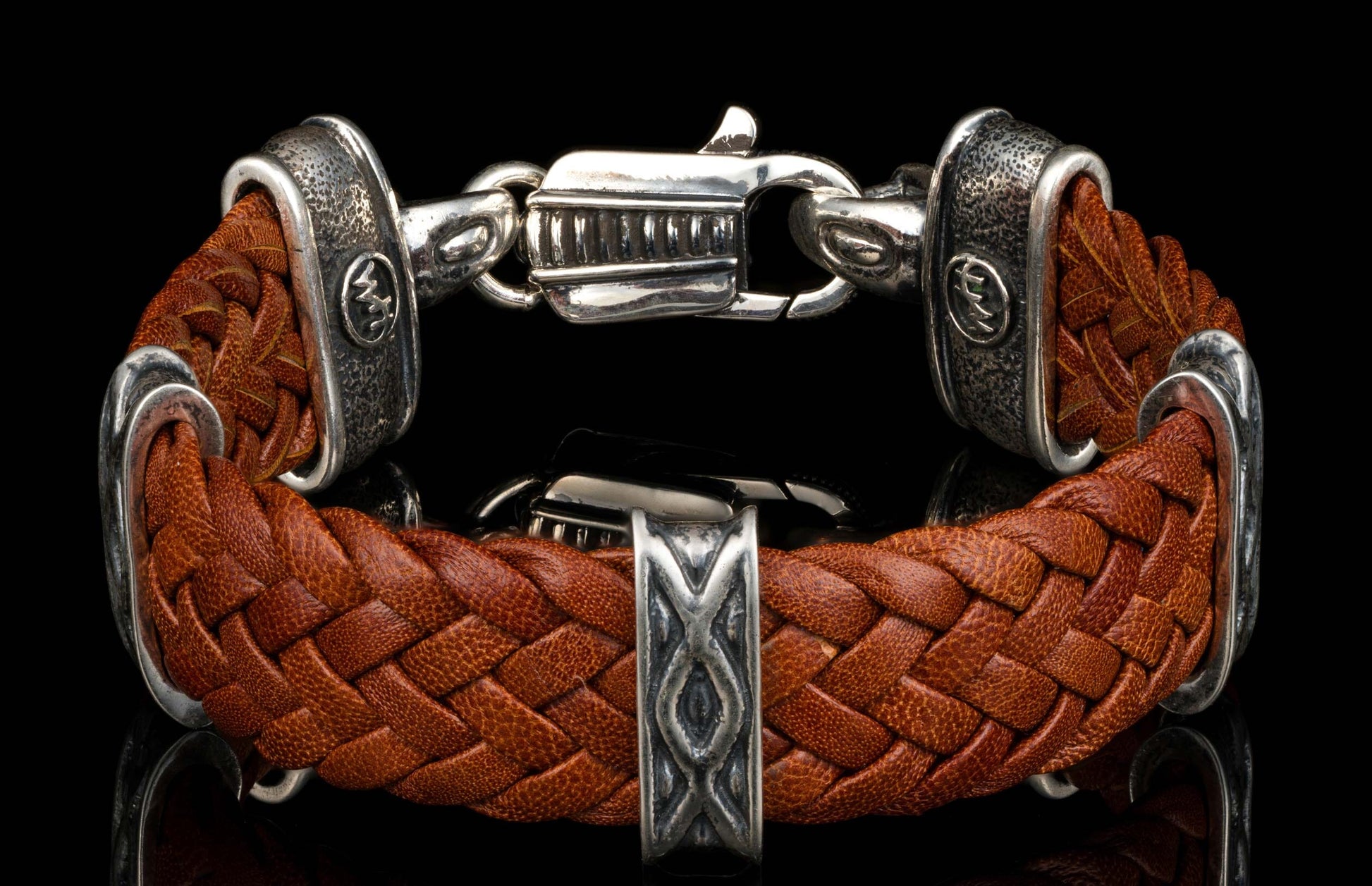 The brown ‘Tilt’ leather bracelet from William Henry features widely woven kangaroo leather adorned with textured and patinated sterling silver details.