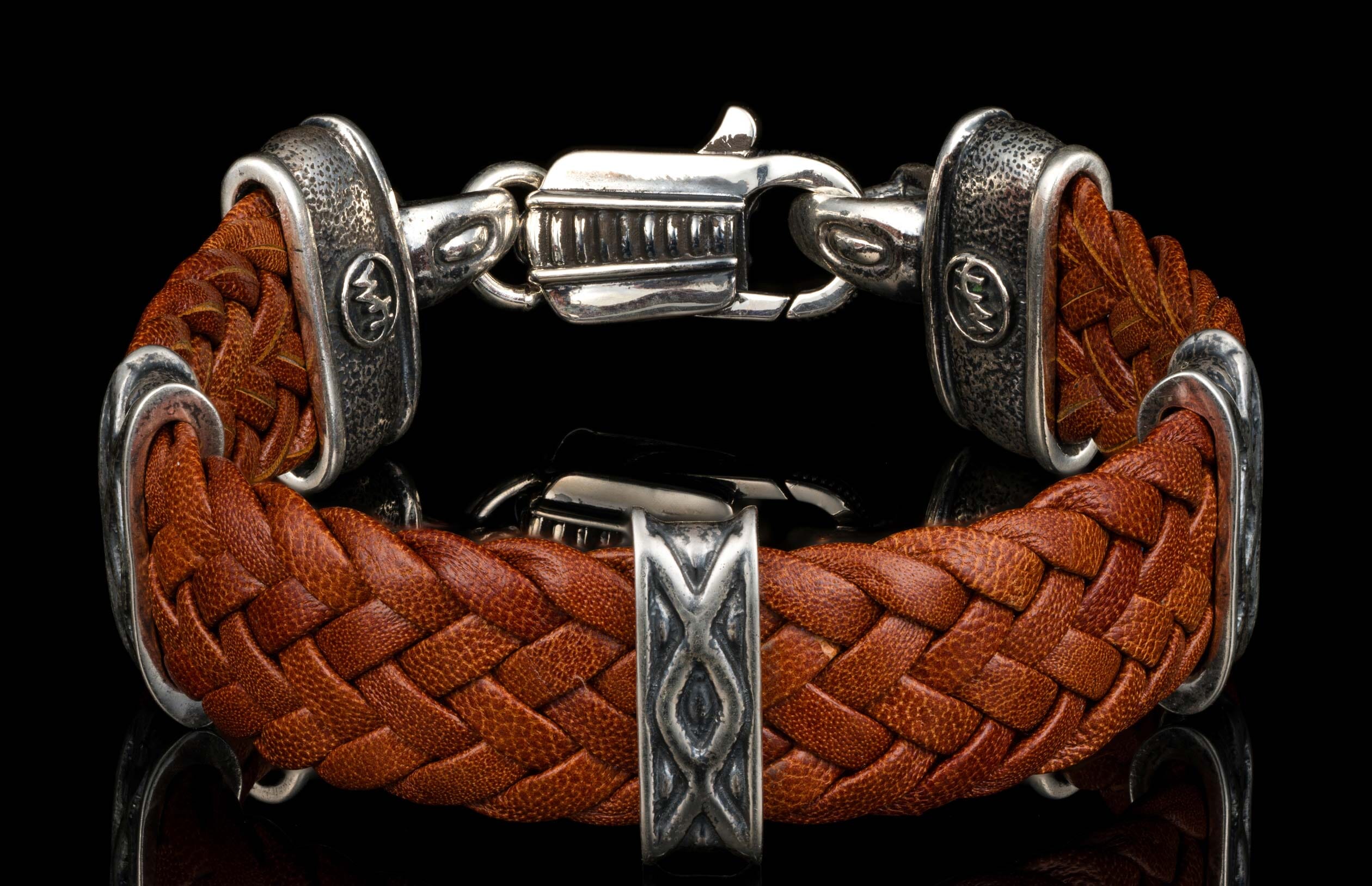 The brown ‘Tilt’ leather bracelet from William Henry features widely woven kangaroo leather adorned with textured and patinated sterling silver details.