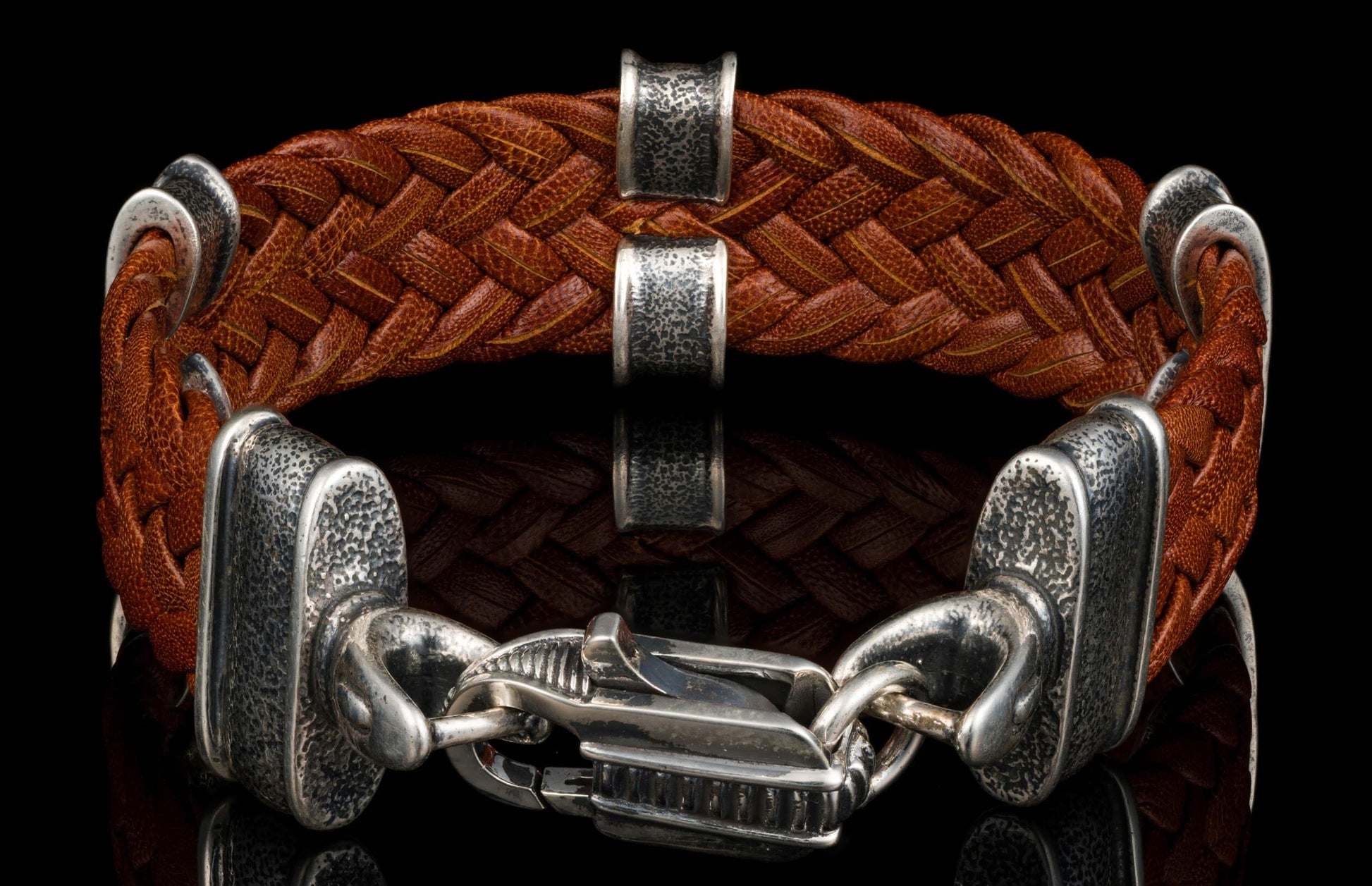 The brown ‘Tilt’ leather bracelet from William Henry features widely woven kangaroo leather adorned with textured and patinated sterling silver details.