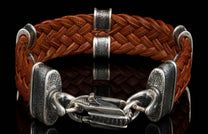 The brown ‘Tilt’ leather bracelet from William Henry features widely woven kangaroo leather adorned with textured and patinated sterling silver details.