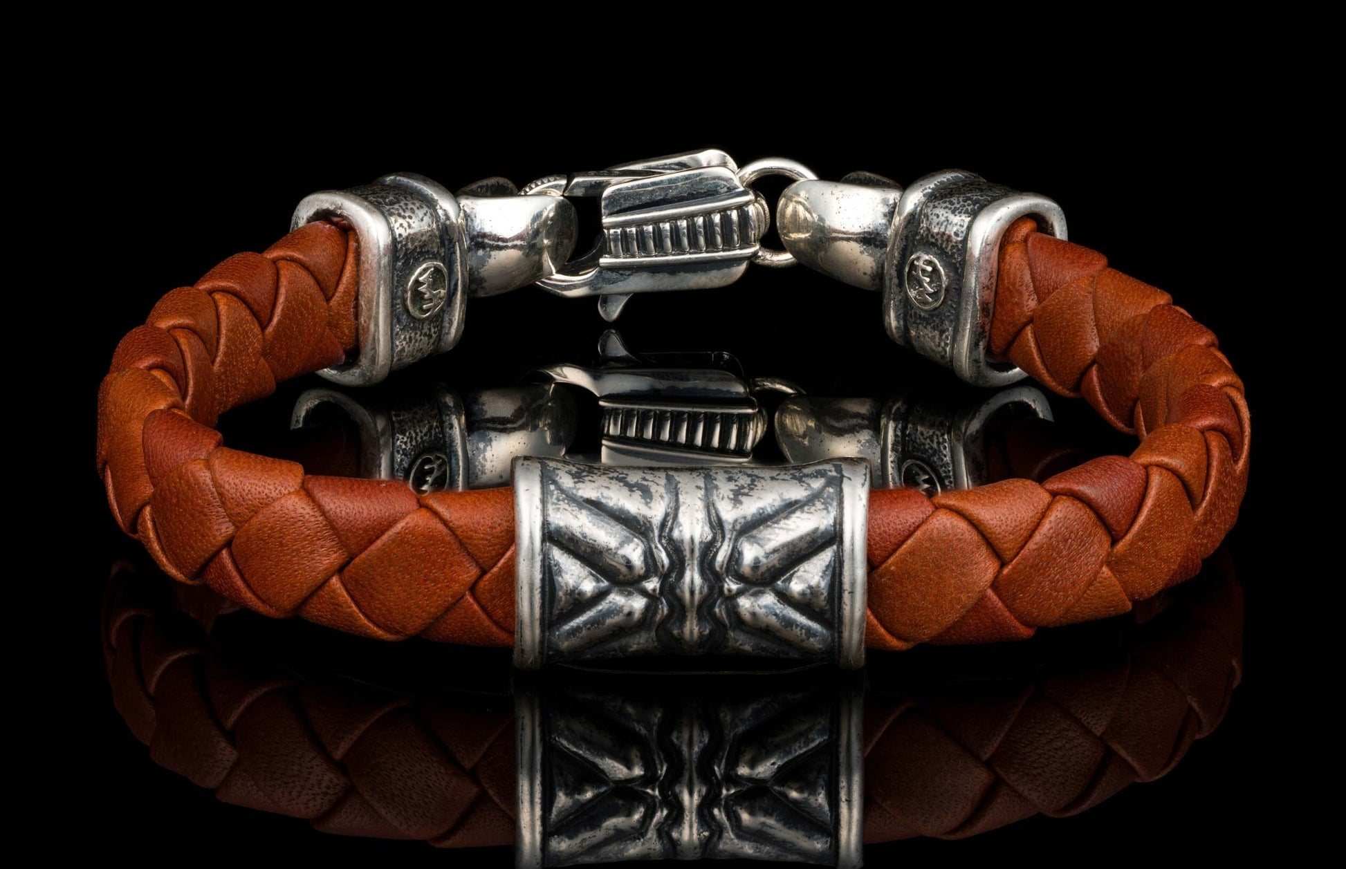 The brown ‘Thunderbloom’ leather bracelet from William Henry features braided lambskin leather adorned with textured and patinated sterling silver details