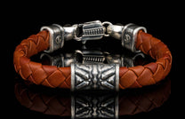 The brown ‘Thunderbloom’ leather bracelet from William Henry features braided lambskin leather adorned with textured and patinated sterling silver details