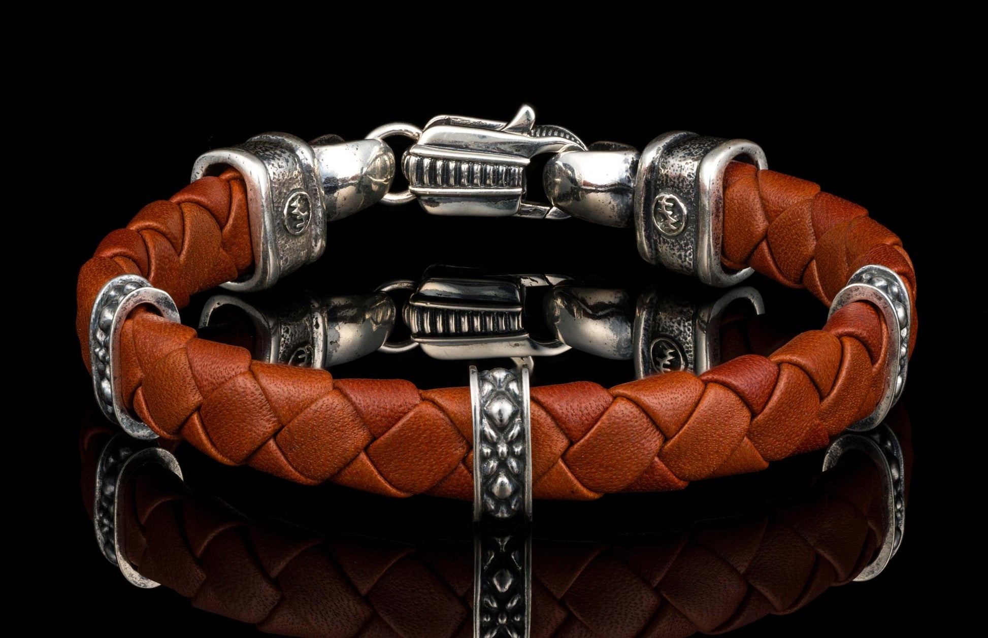 The brown ‘Norn’ leather bracelet from William Henry features braided lambskin leather adorned with textured and patinated sterling silver details.