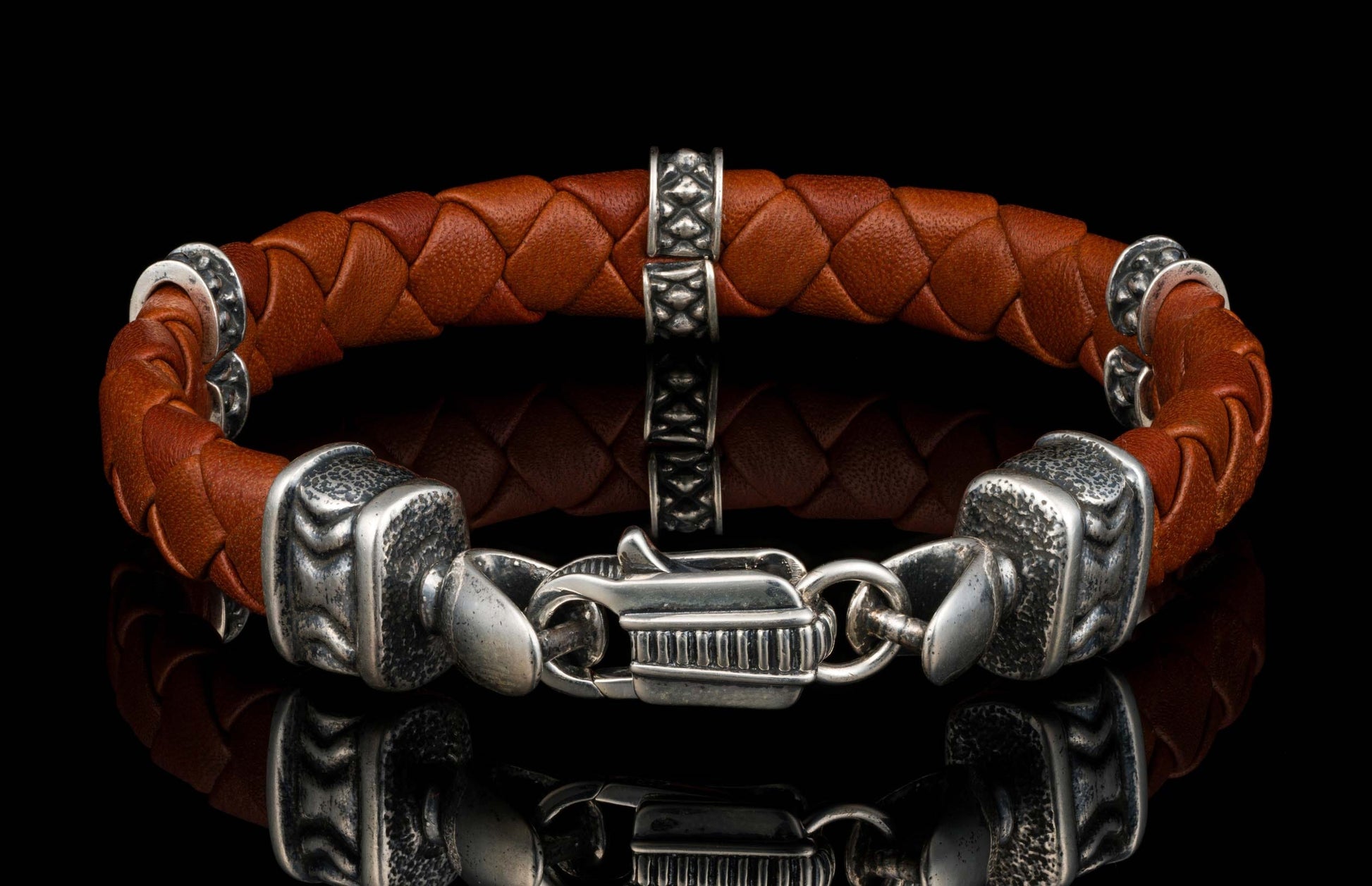 The brown ‘Norn’ leather bracelet from William Henry features braided lambskin leather adorned with textured and patinated sterling silver details.