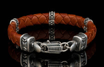 The brown ‘Norn’ leather bracelet from William Henry features braided lambskin leather adorned with textured and patinated sterling silver details.