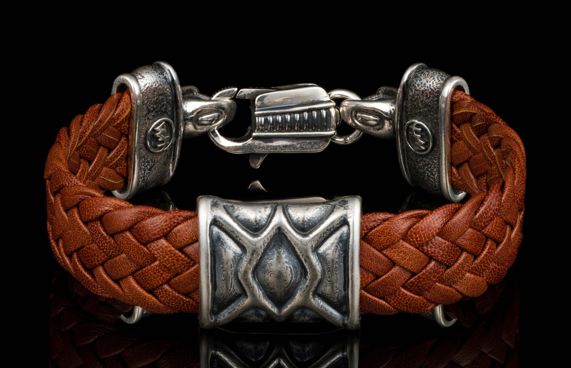 The ‘Rhomb’ leather bracelet from William Henry features brown woven kangaroo leather adorned with textured and patinated sterling silver details.
