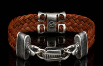 The ‘Rhomb’ leather bracelet from William Henry features brown woven kangaroo leather adorned with textured and patinated sterling silver details.