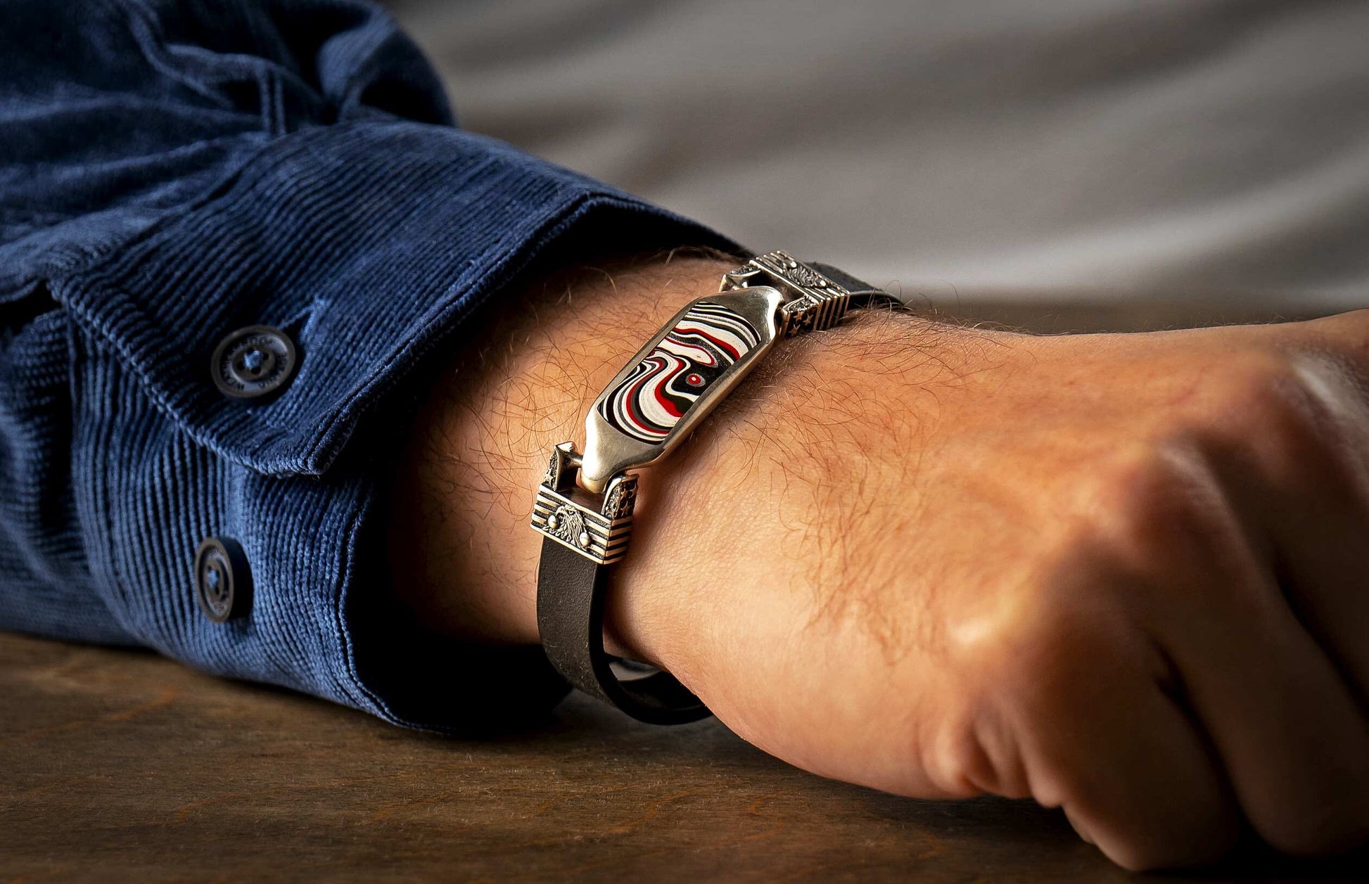 The DeVille Men's Fordite Silver Bracelet on a wrist
