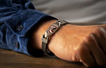 The DeVille Men's Fordite Silver Bracelet on a wrist
