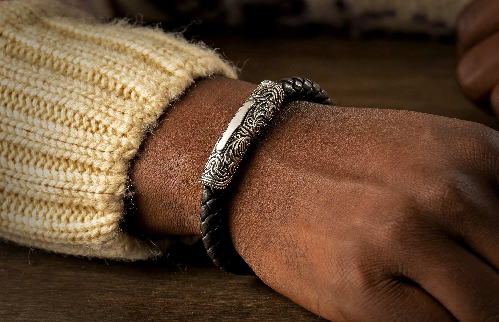 The Milan Silver and Black Braided Leather Bracelet on a wrist