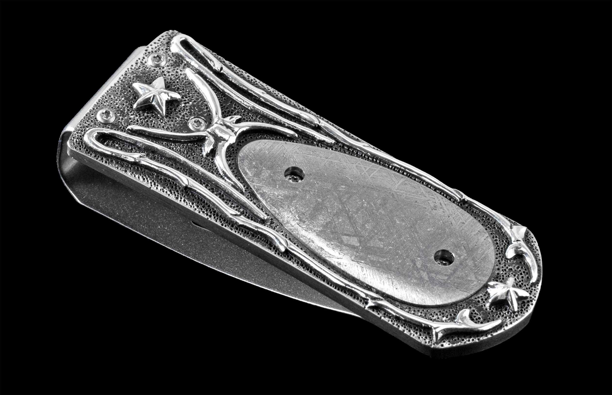Handcrafted luxury money clip from William Henry featuring hand-carved sterling silver inlaid with Gibeon meteorite scales.
