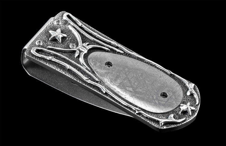Handcrafted luxury money clip from William Henry featuring hand-carved sterling silver inlaid with Gibeon meteorite scales.
