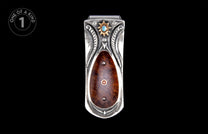Ornate silver money clip with dark burled wood inlay, turquoise stone, and gold sunburst detail.