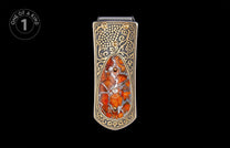 Ornate gold and dark silver money clip with a mottled orange-red stone inlay, accented by gold dots and a clear gemstone.