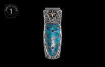 Ornate silver money clip with turquoise stone inlay, intricate scrollwork, and a small copper star.