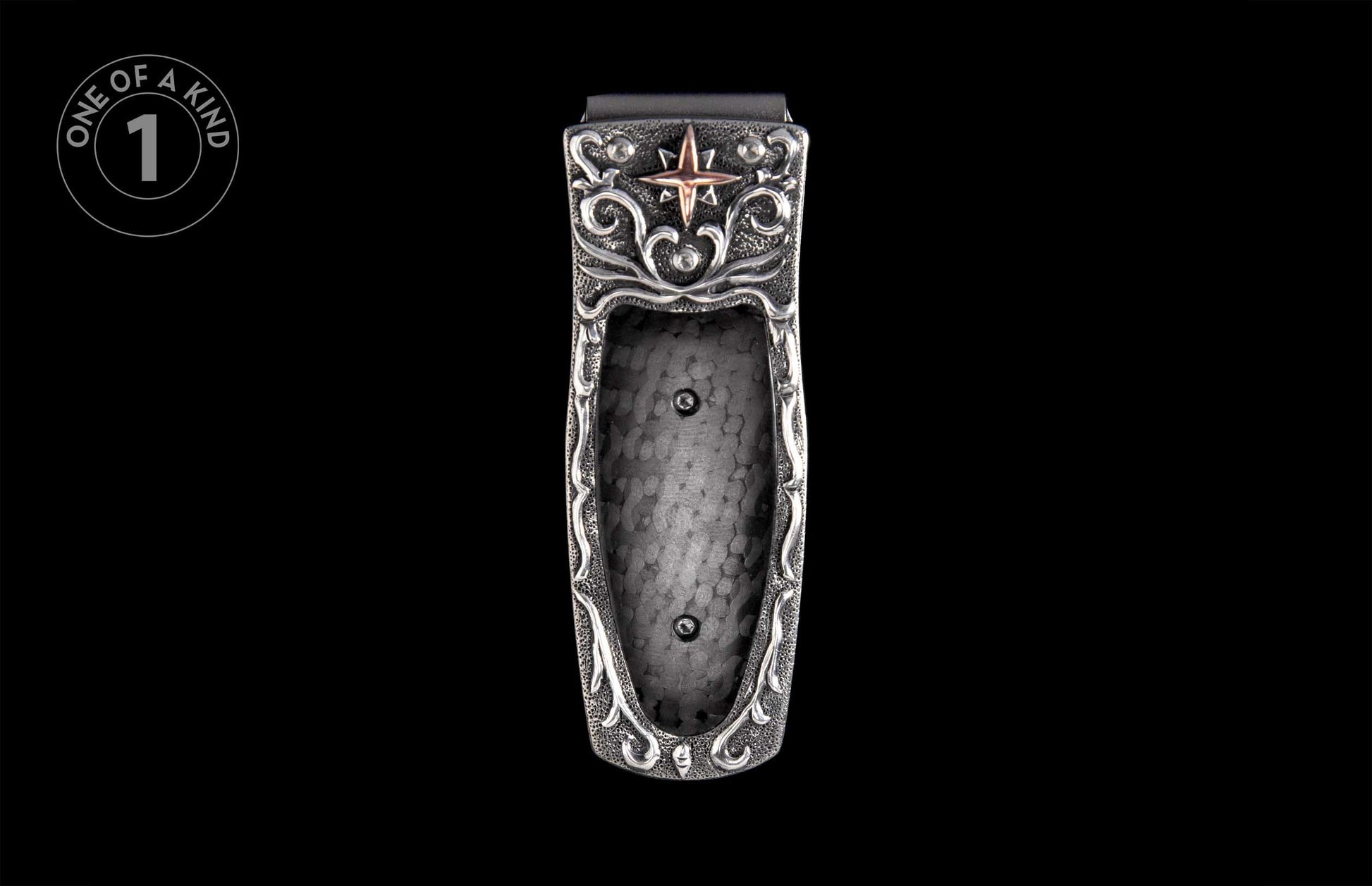 Ornate silver-toned money clip with a prominent copper star, intricate scrollwork, and textured metal finish.