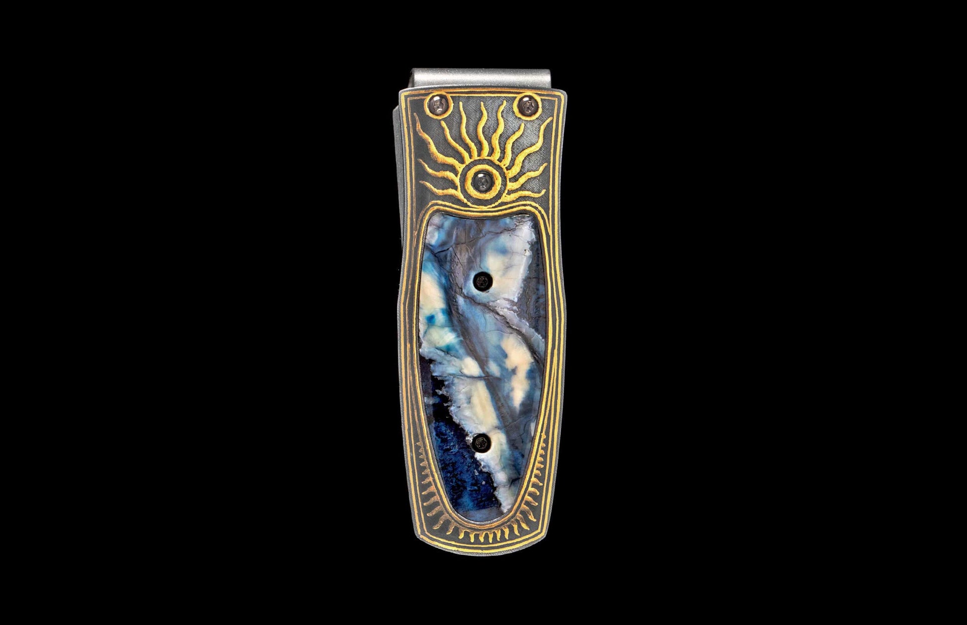 Silver and dark metal money clip with a blue and white marbled inlay, gold sunburst, and patterned trim.