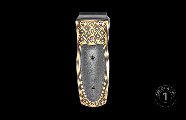 Dark money clip with gold etched Celtic knotwork pattern on Damascus steel, featuring three visible screws.