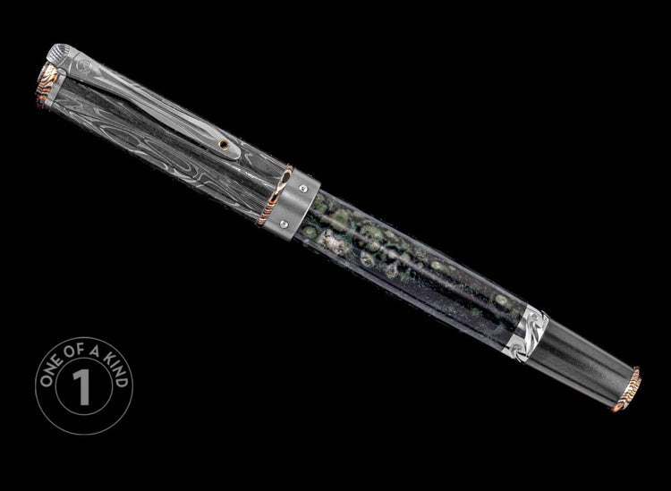 One of a Kind pen from William Henry featuring a moss agate barrel, hand forged Damascus cap, spinel gemstone, and Mokume Gane accents.