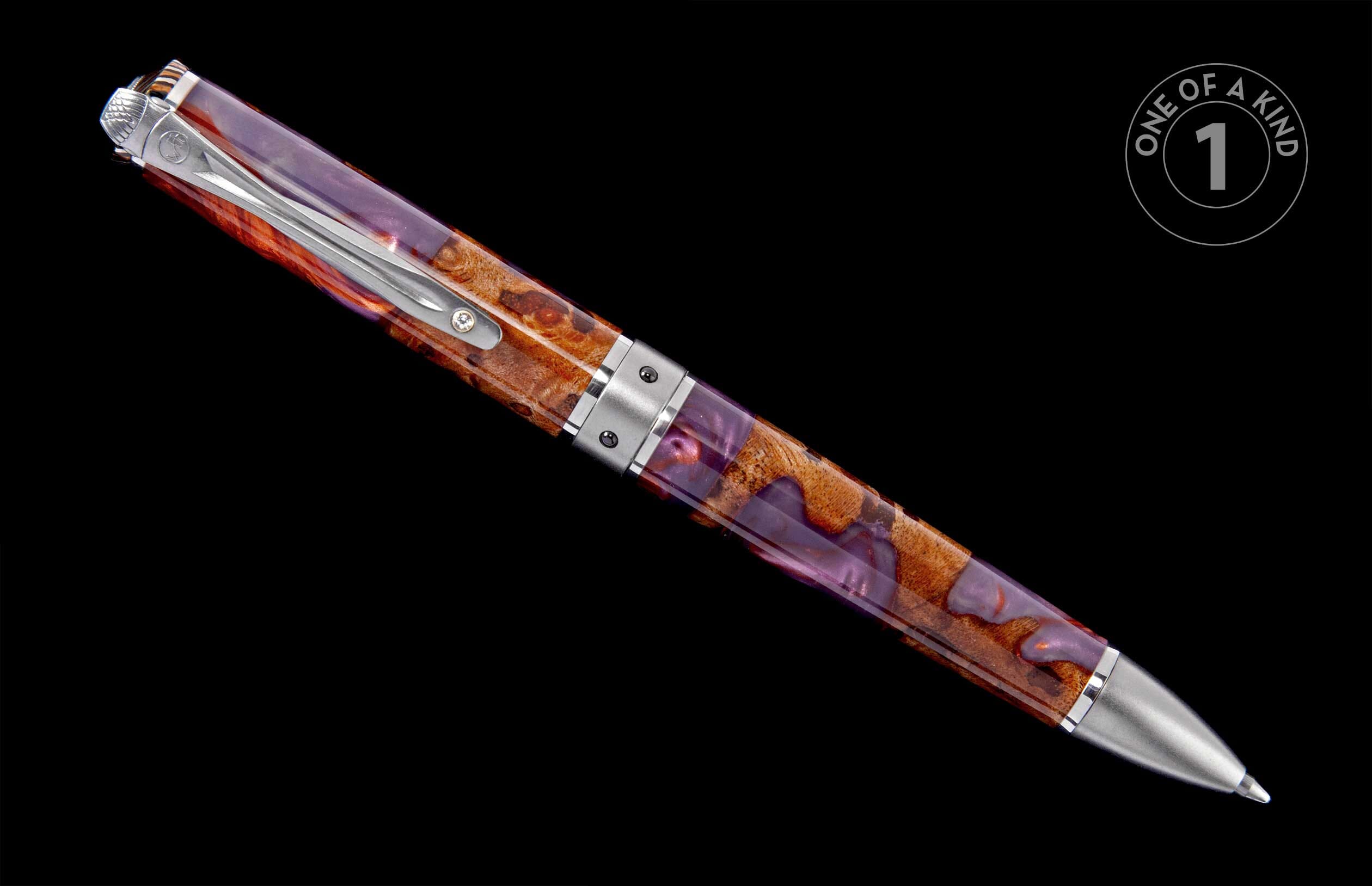 Reddish-brown wood burl and purple resin pen with silver-tone hardware and a decorative clip, positioned diagonally.