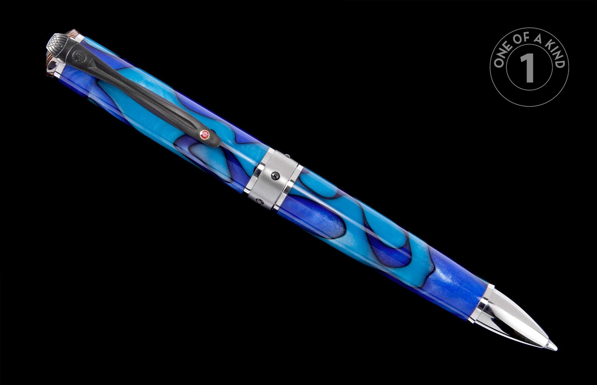 Vibrant blue swirled pen with silver-toned ends, a dark clip featuring a red jewel, and a "ONE OF A KIND" graphic.