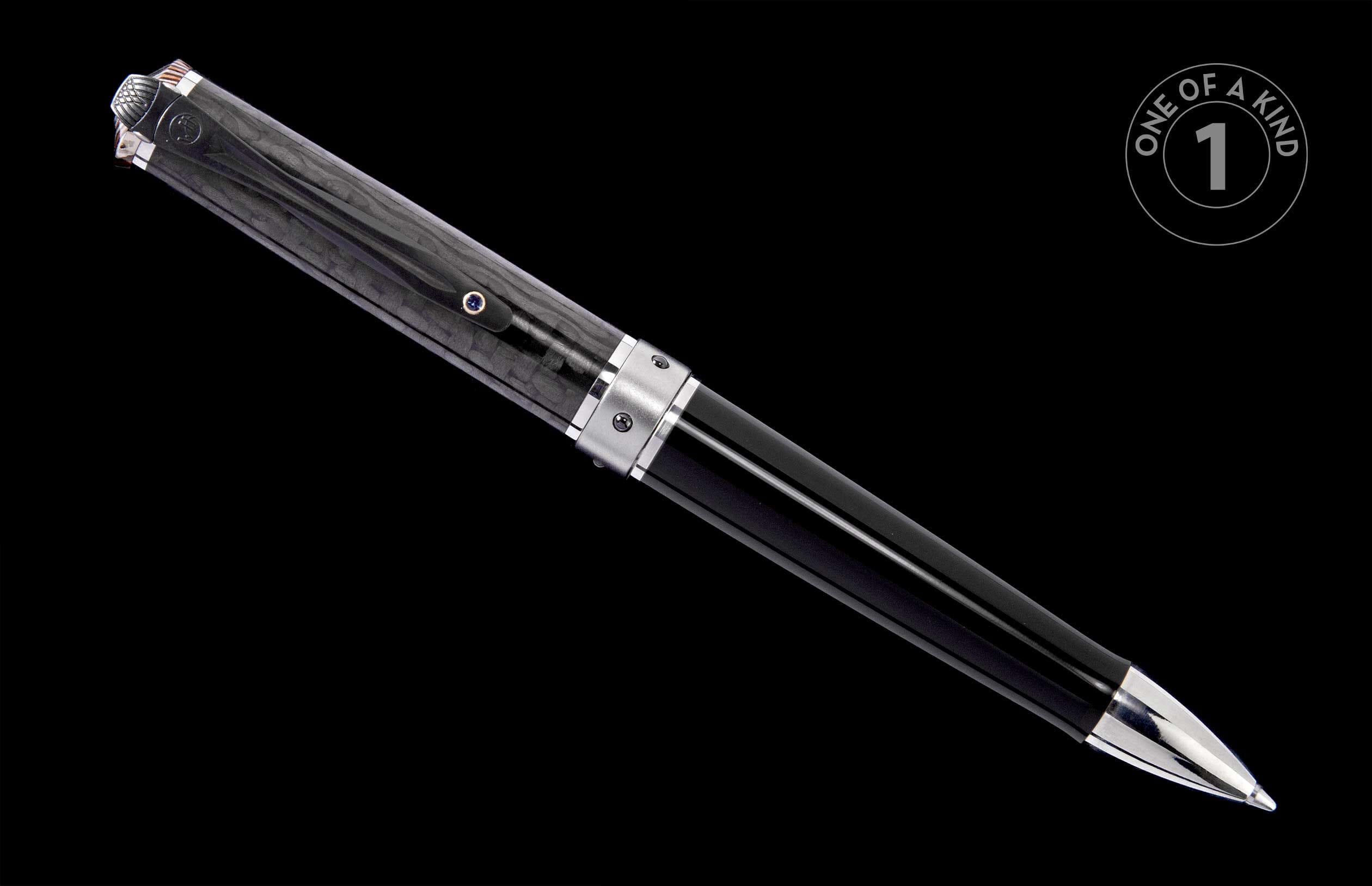 Black textured pen with silver accents and a small blue gemstone, angled.