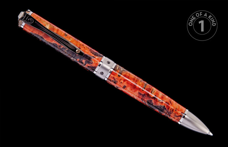 Orange and black swirled resin pen with silver-toned metal accents and a black clip on a black background.