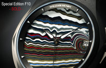 Fordite dial watch by William Henry, featuring layered multicolor marbled pattern, black hands, date window, and textured bezel in close-up view