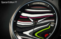 Special Edition Fordite watch by William Henry featuring multicolored marbled dial with black, white, red, and neon green swirls, diamond-shaped hour markers, and sleek silver case in close-up view