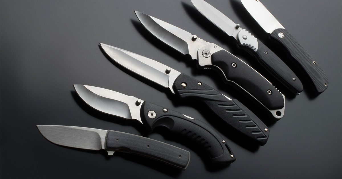 row of black pocket knives
