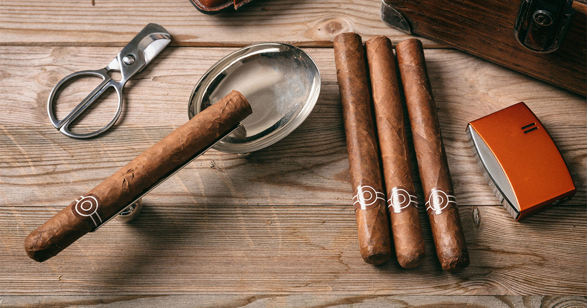 Cigars on table with cigar cutter