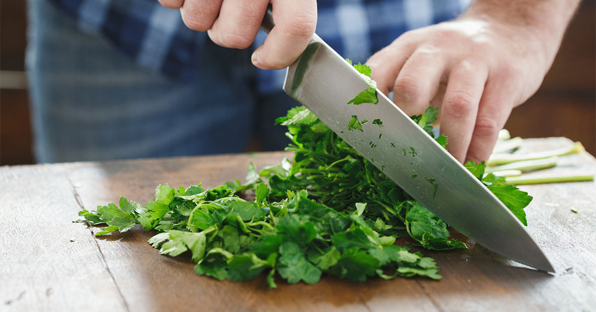 Cutting parsley with kitchen knife