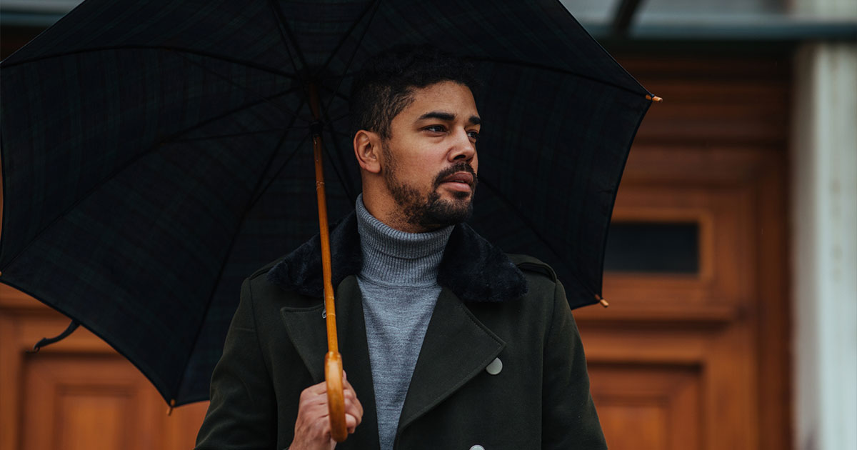 Fancy dressed man with umbrella