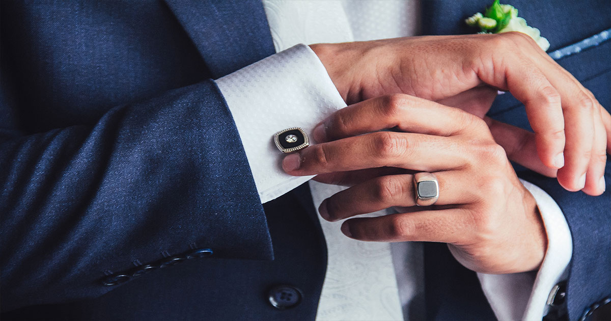 Groomsman adjusting cufflinks