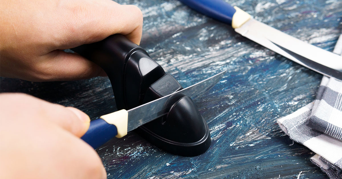 Man sharpening kitchen knife