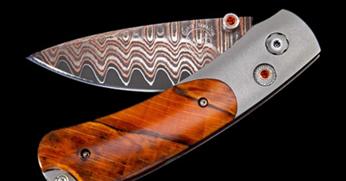 Brown folding pocket knife on black background