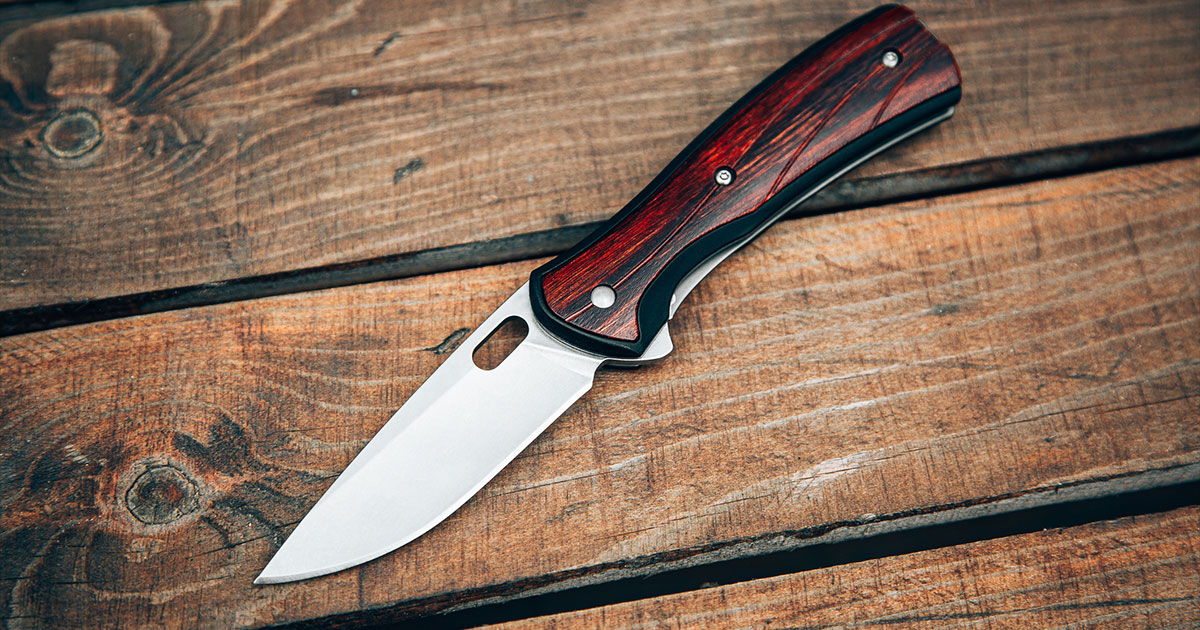 Pocket knife on wood bench